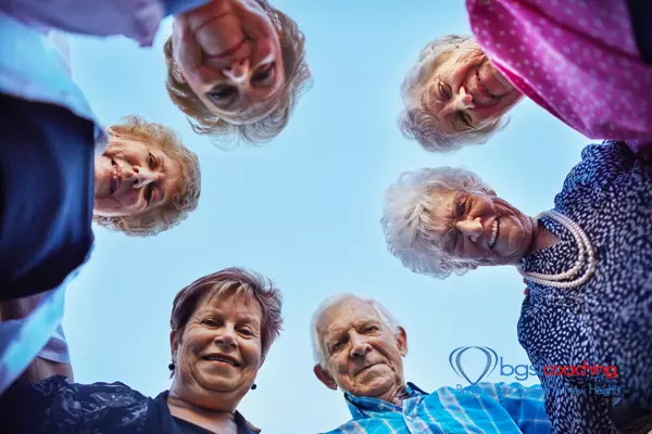Living Life | BGSICoaching | 7 senior adults looking down at camera